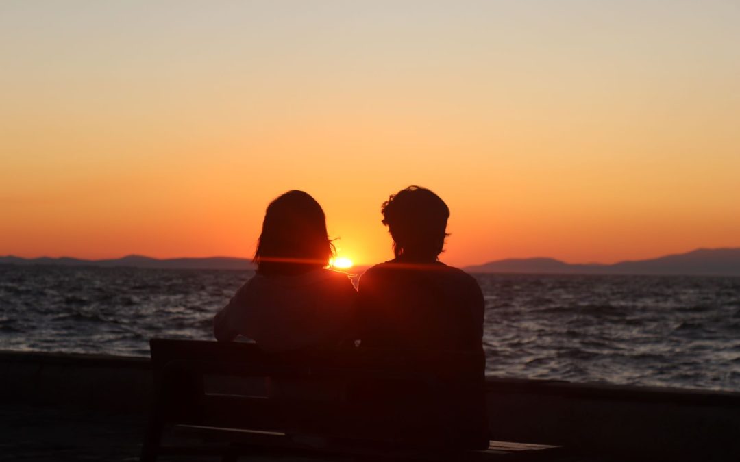 two lovers watching sunset
